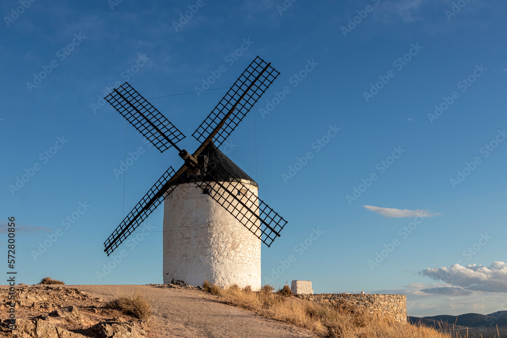 Traditional windmill on a mountain at sunset of Consuegra, Toledo province, Castilla la Mancha, Spain Traditional windmill on a mountain at sunset of Consuegra, Toledo province, Castilla la Mancha, Spain