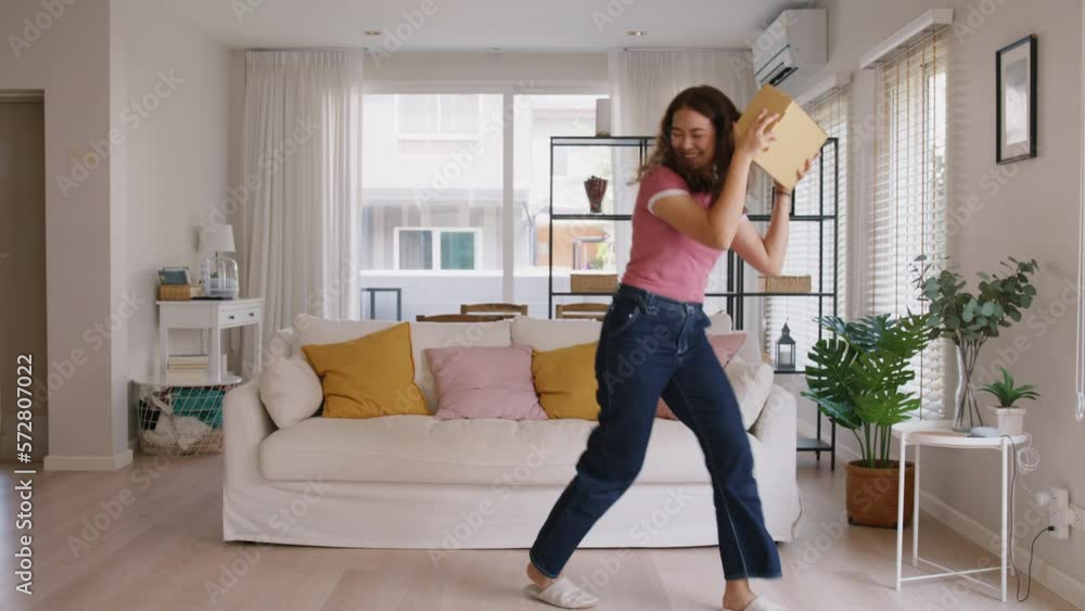 Asia people young Gen Z woman smile carry parcel box goods carton packaging happy joy fun dance at home. Omni channel enjoy buy gift order postal at retail online shop store fast courier send service. Asia people young Gen Z woman smile carry parcel box goods carton packaging happy joy fun dance at home. Omni channel enjoy buy gift order postal at retail online shop store fast courier send service.