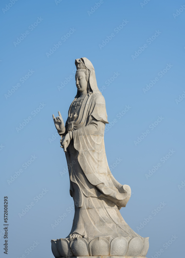 statue of Guanyin (a Buddhism god) on blue sky statue of Guanyin (a Buddhism god) on blue sky