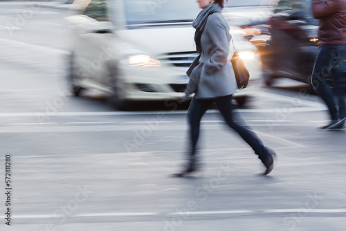 woman crossing a street in the city