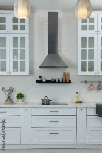 Elegant kitchen interior with range hood and furniture © New Africa