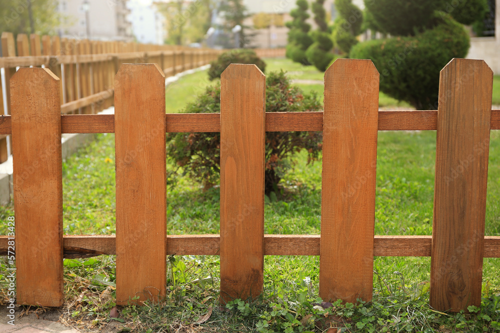 Small wooden fence on sunny day outdoors
