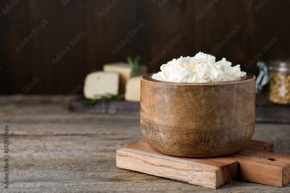 Delicious tofu cream cheese in bowl on wooden table, space for text Delicious tofu cream cheese in bowl on wooden table, space for text