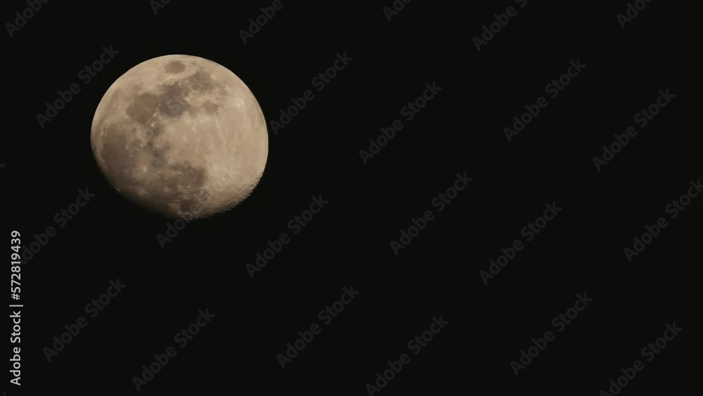 Waxing gibbous moon phase timelapse, moving on dark black sky at night Waxing gibbous moon phase timelapse, moving on dark black sky at night