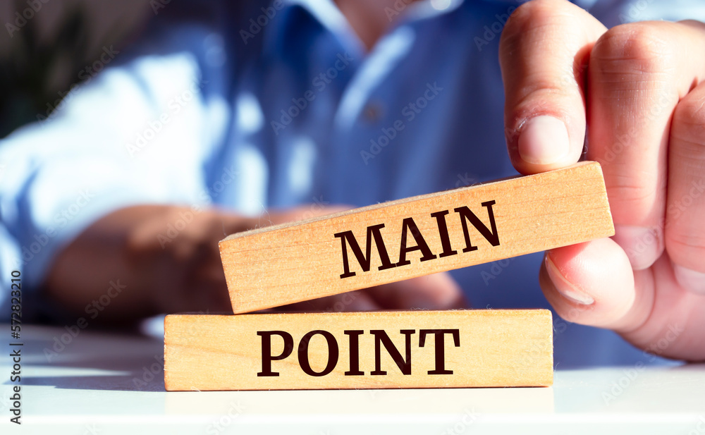 Closeup on businessman holding a wooden block with MAIN POINT message, business concept Closeup on businessman holding a wooden block with MAIN POINT message, business concept