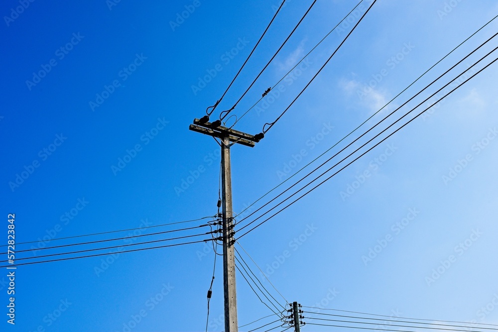 Electric power lines against blue sky background. Electric power lines against blue sky background.