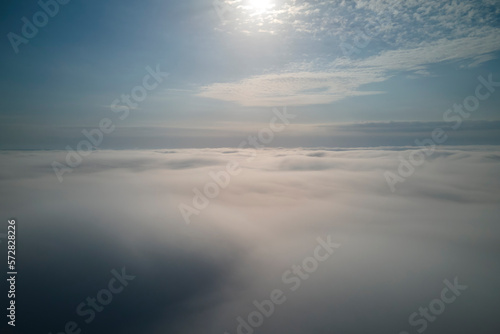 Aerial view from high altitude of earth covered with puffy rainy clouds forming before rainstorm