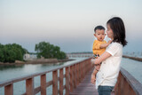 happiness travel baby and mom sunset water atmosphere on sea ,asian baby and mother travel outdoor