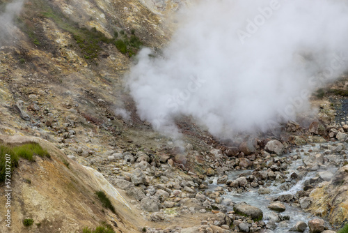 Steam over hot geothermal springs in a mountain gorge. Travel, tourism and hiking on the Kamchatka Peninsula. Nature of the Russian Far East. Small Valley of Geysers, Kamchatka Territory, Russia.