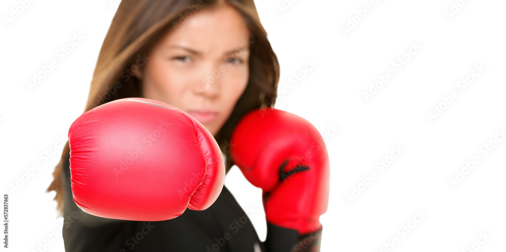 Boxing business woman punching towards camera wearing boxing gloves. Focus on boxing glove. Businesswoman isolated cutout PNG on transparent background.
