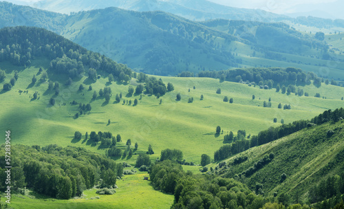 Hills and meadows in the evening light, spring greenery, countryside