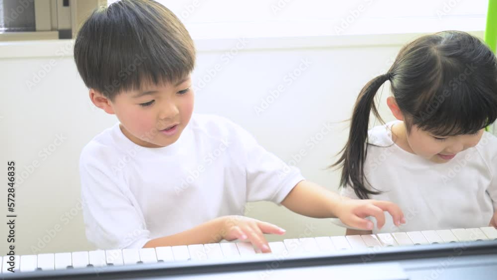 Children playing piano together Children playing piano together
