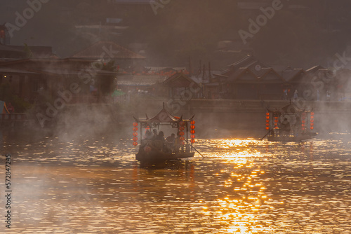 Chinese boat at Ban Rak Thai village in Mae Hong Son province, Thailand. Chinese characters on red lantern - Translated text means happy, lucky, wealthy photo