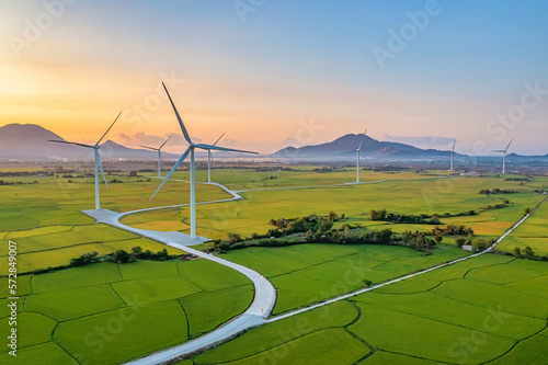 Fototapeta Naklejka Na Ścianę i Meble -  Panoramic view of wind farm or wind park, with high wind turbines for generation electricity with copy space. Green energy concept. Ninh Thuan, Vietnam