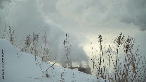 Smoke from the pipes from, rising up, in a blurry background. photo