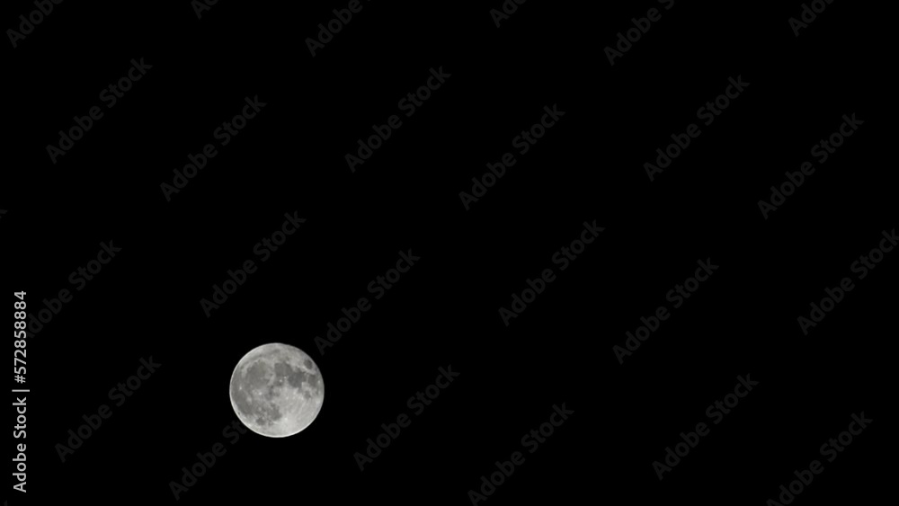 Moon Timelapse, Stock time lapse : Full moon rise in dark nature sky, night time. Full moon disk time lapse with moon light up in night dark black sky. High-quality free video footage or timelapse
