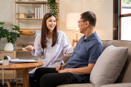 Female doctor visit male elderly patient at home and explaining