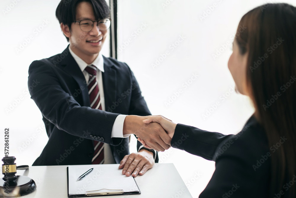 Female lawyer shaking hands with client after discussing deal of Female lawyer shaking hands with client after discussing deal of