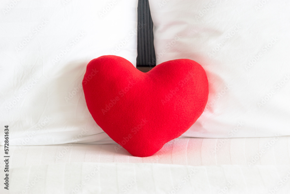 Close up of Red heart and Couple white pillow on the bed for love, wedding and valentine's day concept Close up of Red heart and Couple white pillow on the bed for love, wedding and valentine's day concept