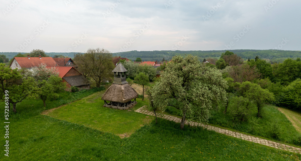 Old wooden bell tower with thatched roof. The region's symbolic landmark.  Part of the Orseg national Park in Hungary.
