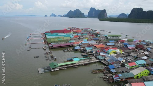 Aerial drone view flying over the floating fishing village at Ko Panyi (or Koh Panyee) one of travel destination in Phang Nga Bay, Phang Nga province, Thailand. 4K footage video