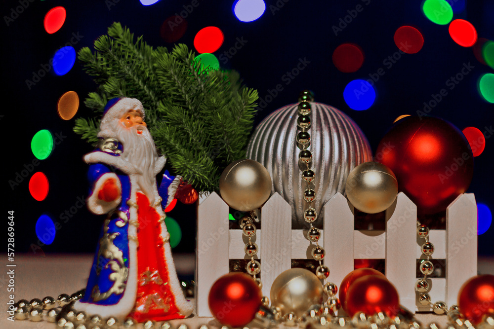 Christmas card with Santa Claus,Snow Maiden.Christmas tree. on a dark background with bright flashing lights of garlands.A statuette, a Santa Claus toy.Christmas tree toys on the Christmas tree. bokeh