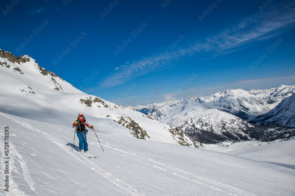 A skier descends to a notch during the Spearhead Traverse in the Coast Mountains of British Columbia, Canada. A skier descends to a notch during the Spearhead Traverse in the Coast Mountains of British Columbia, Canada.