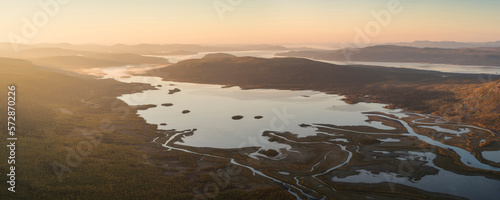 Autumn sunrise over lake Laitaure and Rapadalen from summit of Skierfe, near Aktse hut, Kungsleden trail, Lapland, Sweden photo