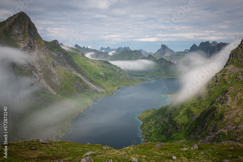 Fog forms amongs the mountains surrounding Forsfjord, MoskenesÃ¸y, Lofoten Islands, Norway photo