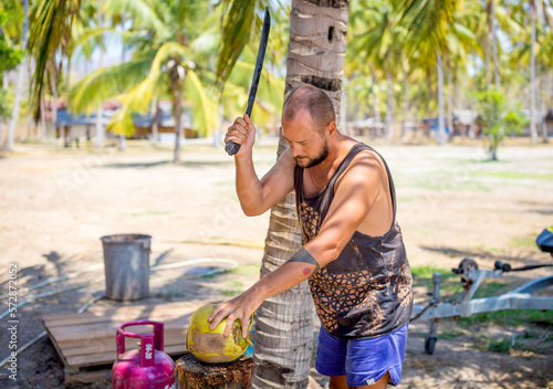 Young man wirh coconut.Sumbawa.Indonesia. photo