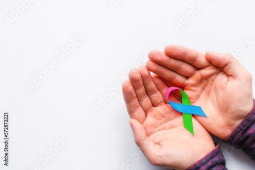 man holding a symbol of World AIDS Day photo