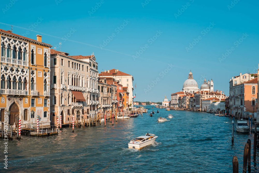 The Grand Canal with Venetian Gothic buildings and Basilica di Santa Maria della Salute, the domed baroque church in Venice, Italy