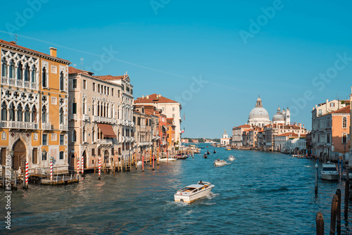 The Grand Canal with Venetian Gothic buildings and Basilica di Santa Maria della Salute, the domed baroque church in Venice, Italy © Isra.Suvachart