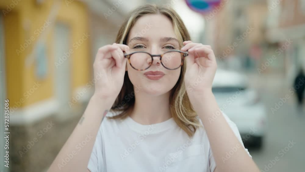 Young caucasian woman smiling confident wearing glasses at street Young caucasian woman smiling confident wearing glasses at street