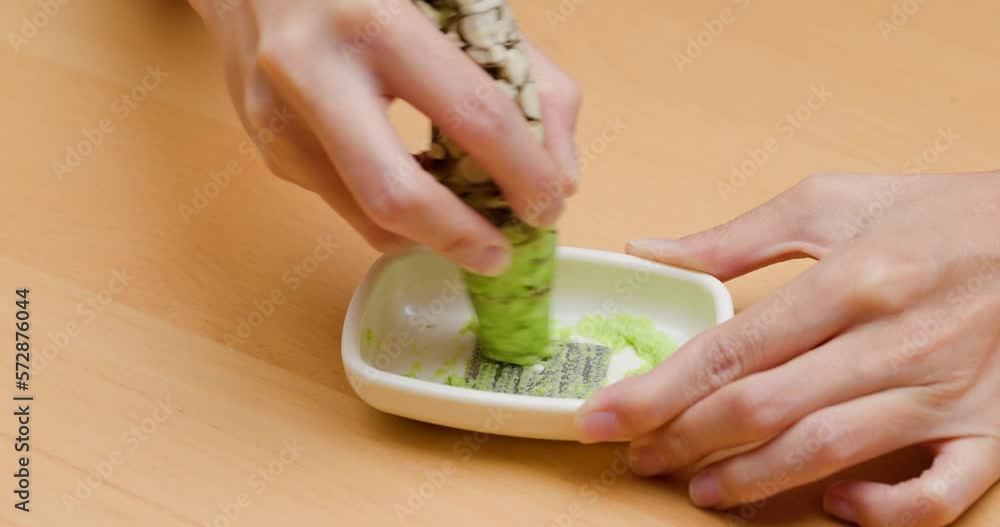 Grating fresh wasabi by skin grater Stock Video Adobe Stock