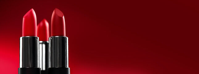 Lipstick. Fashion red colorful Lipsticks over red background. Matt Red lipstick tints palette, Professional Makeup and beauty. Beautiful Make-up concept. Lipgloss. Lipsticks closeup, border