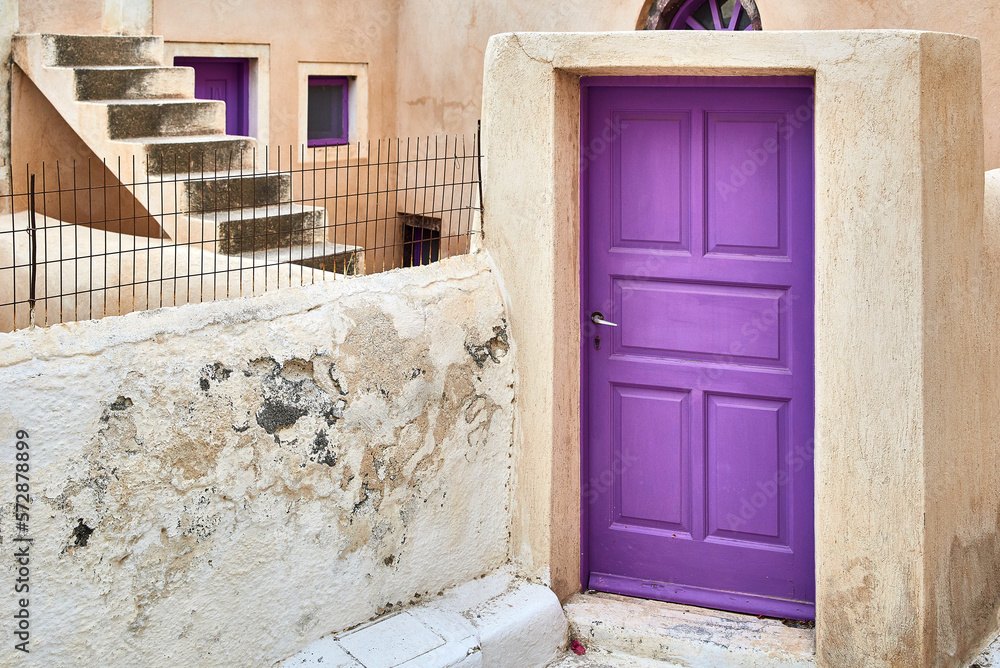 Purple front door to a house in an old minimalist Greek village