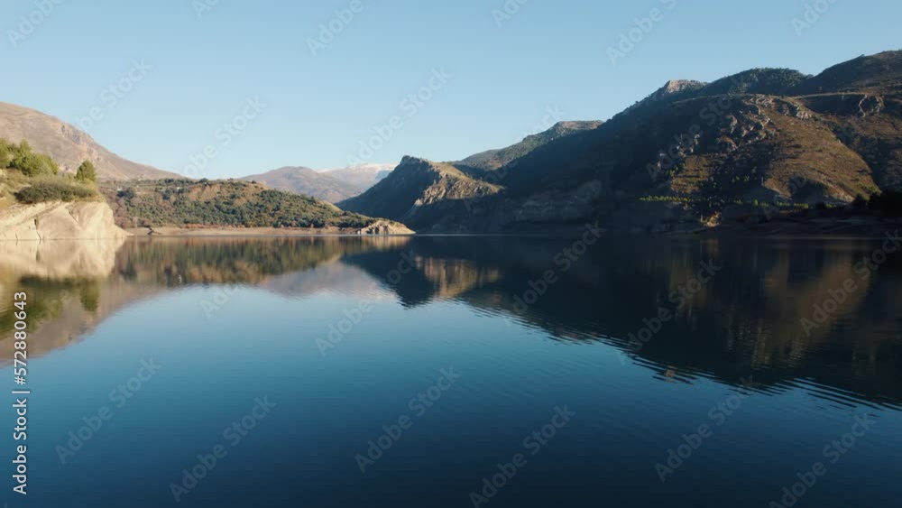Guejar river with calm water and huge rocky cliffs in its banks on a sunny day Guejar river with calm water and huge rocky cliffs in its banks on a sunny day