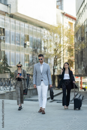 Three business people walking