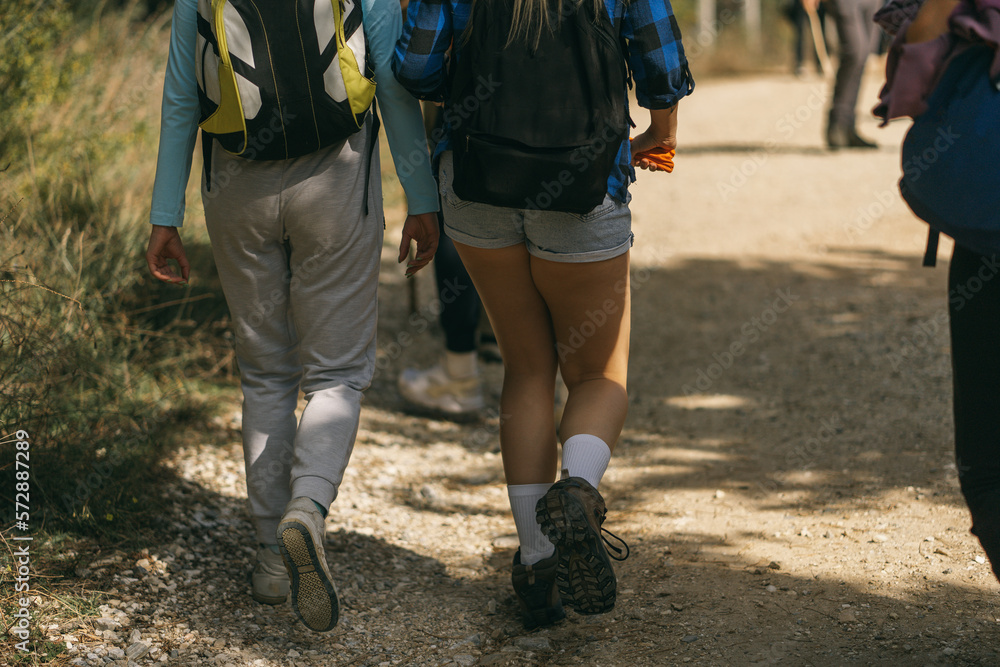 Close up of hikers walking into the forest Close up of hikers walking into the forest