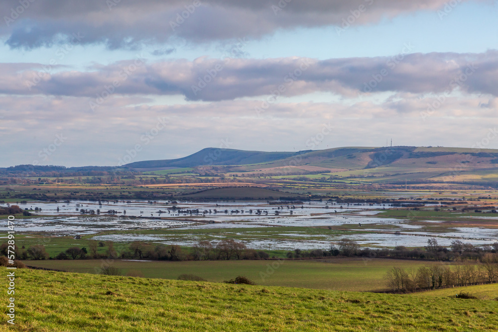 Looking out towards Firle Beacon from the South Downs near Lewes, with flooded fields at Iford inbetween