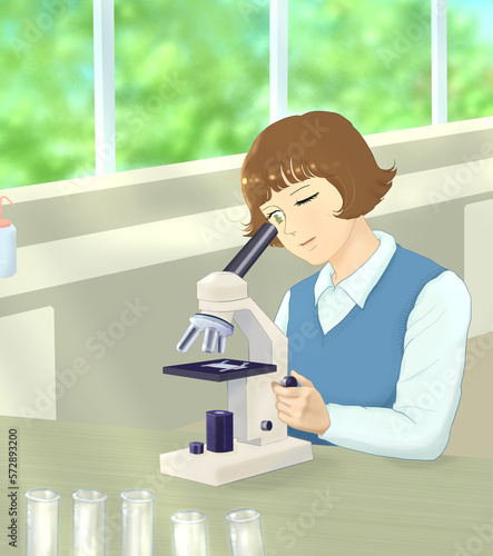 female student looking through a microscope in the lab