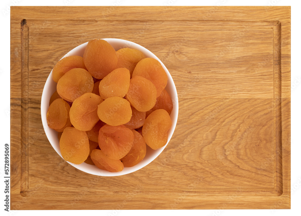 dried apricots in ceramic bowl on wooden board isolated on white, top view, flat lay, concept of healthy breakfast dried apricots in ceramic bowl on wooden board isolated on white, top view, flat lay, concept of healthy breakfast
