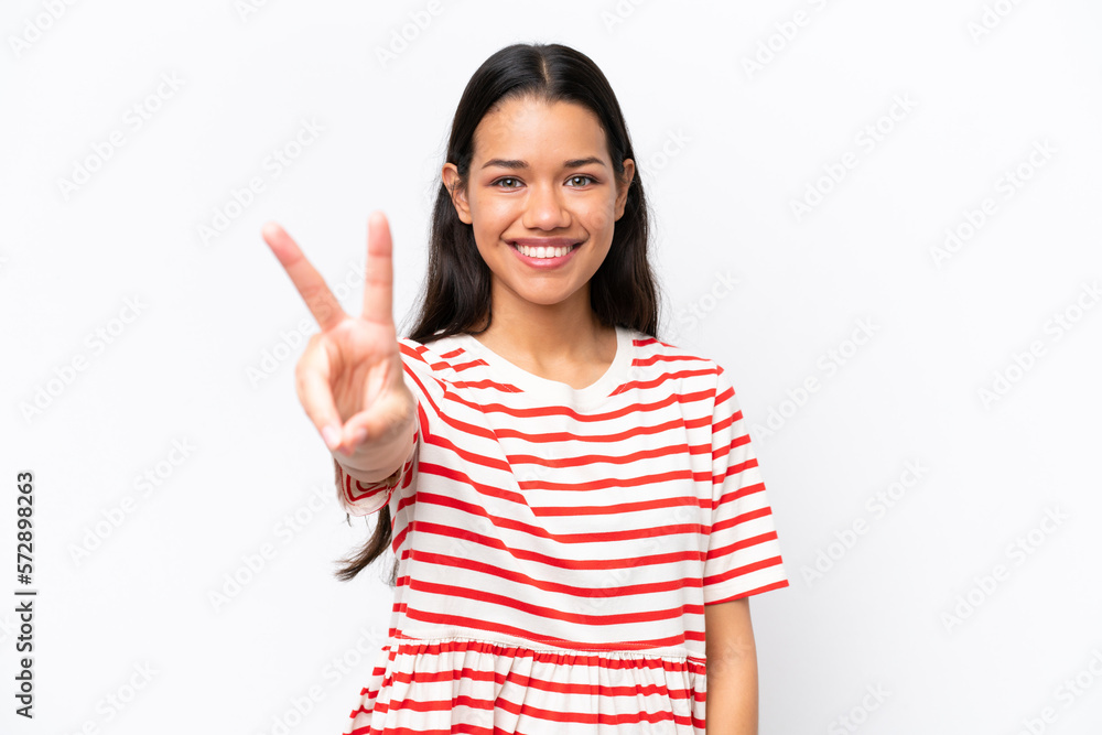 Young Colombian woman isolated on white background smiling and showing victory sign Young Colombian woman isolated on white background smiling and showing victory sign