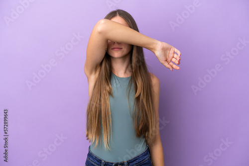 Young Lithuanian woman isolated on purple background covering eyes by hands