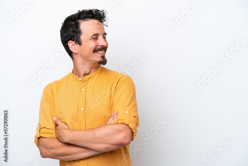Young man with moustache isolated on white background with arms crossed and happy