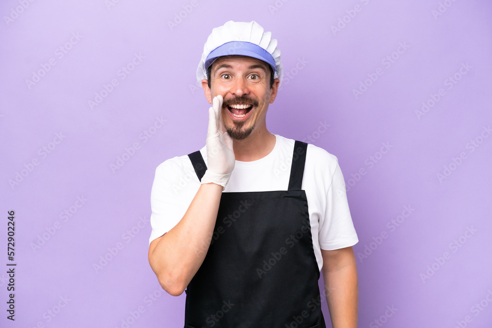 Fishmonger man wearing an apron isolated on purple background shouting with mouth wide open