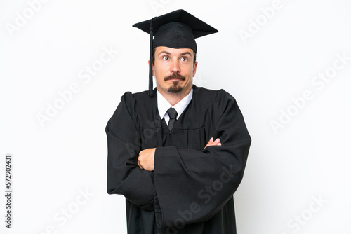 Young university graduate man isolated on white background making doubts gesture while lifting the shoulders