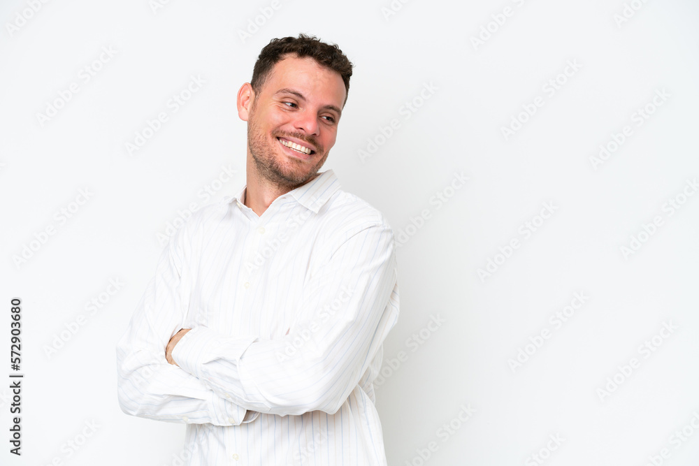 Young caucasian handsome man isolated on white background with arms crossed and happy Young caucasian handsome man isolated on white background with arms crossed and happy