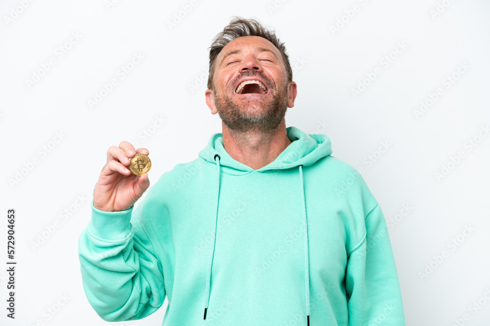 Middle age man holding a Bitcoin over isolated background laughing Middle age man holding a Bitcoin over isolated background laughing